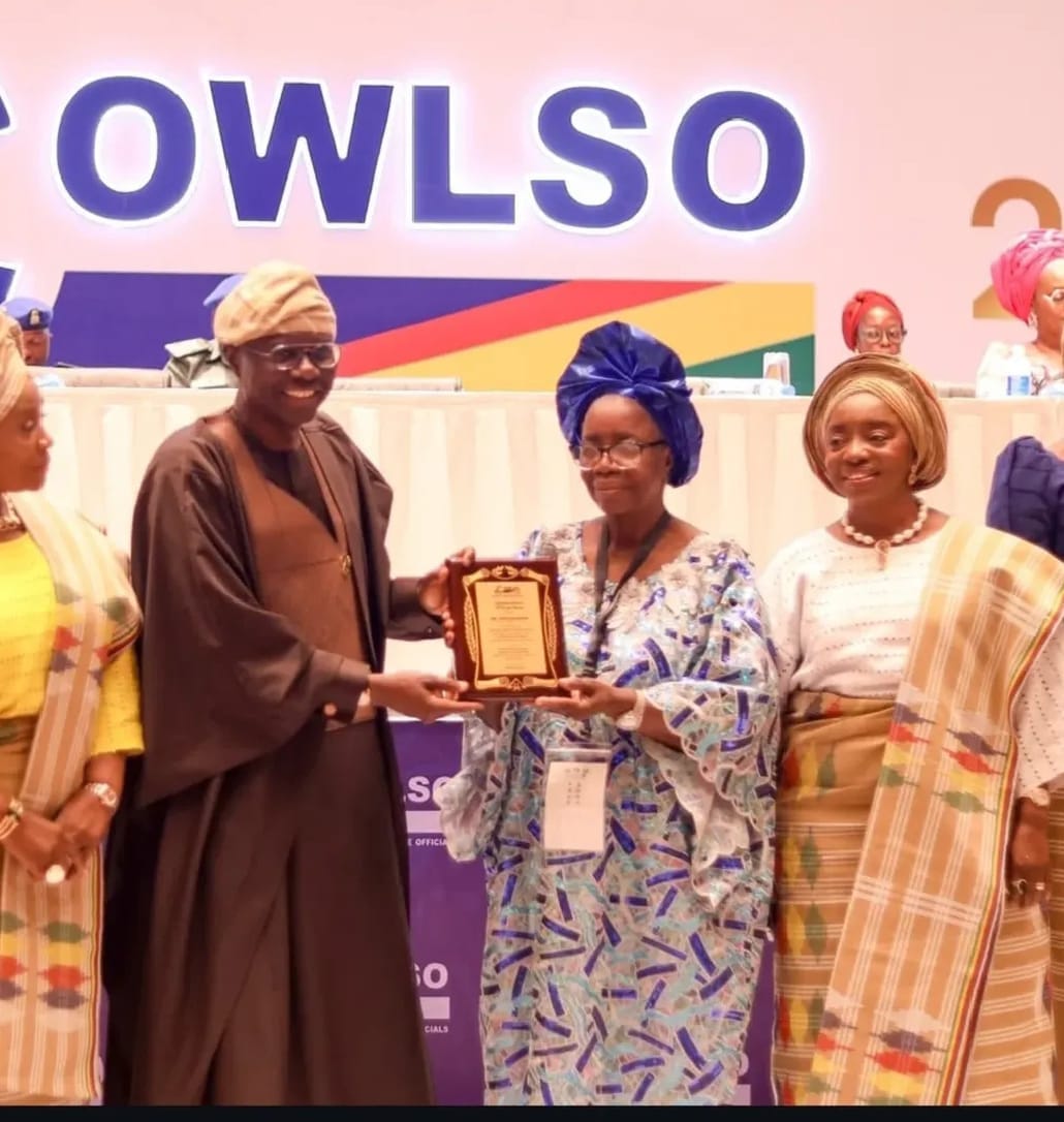 Lagos State Governor presenting award to the Founder Home of God's Grace for Orphans and Widows